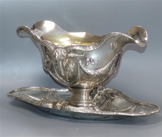 An ornate 800 standard white metal double lipped sauceboat dish, with rams head and swag decoration, 26 oz.